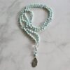 Hemimorphit (facettiert) -Bergkristall (facettiert) -Apatit (blau, facettiert) -Mala  mit Edelstahl-Anhänger (Hamsa-Hand)