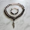Granat (facettiert) -Rauchquarz (facettiert) -Rosenquarz (facettiert) -Mala (2) mit Edelstahl-Anhänger (Engelsflügel) und Armband